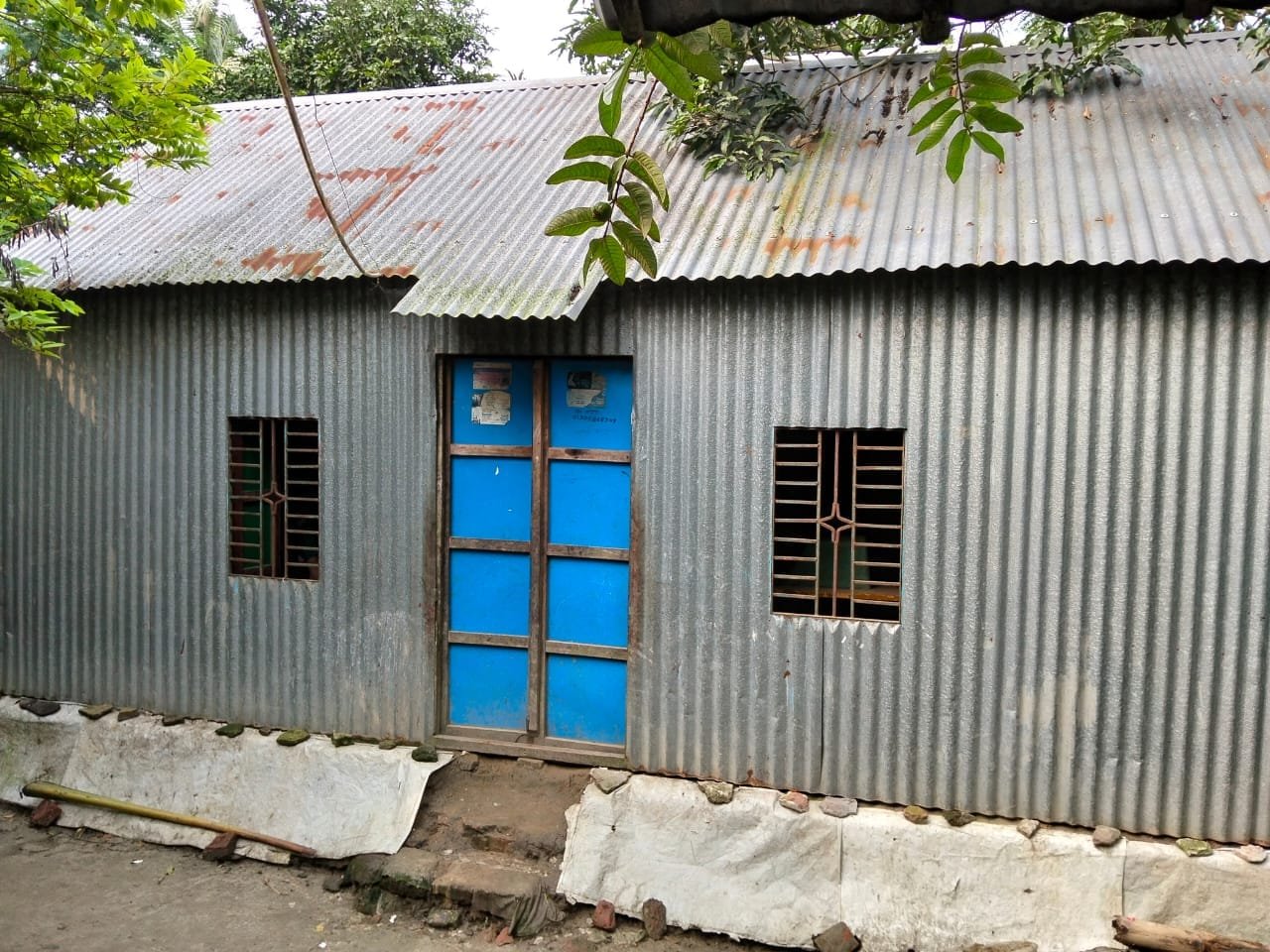 Tin house with blue windows.